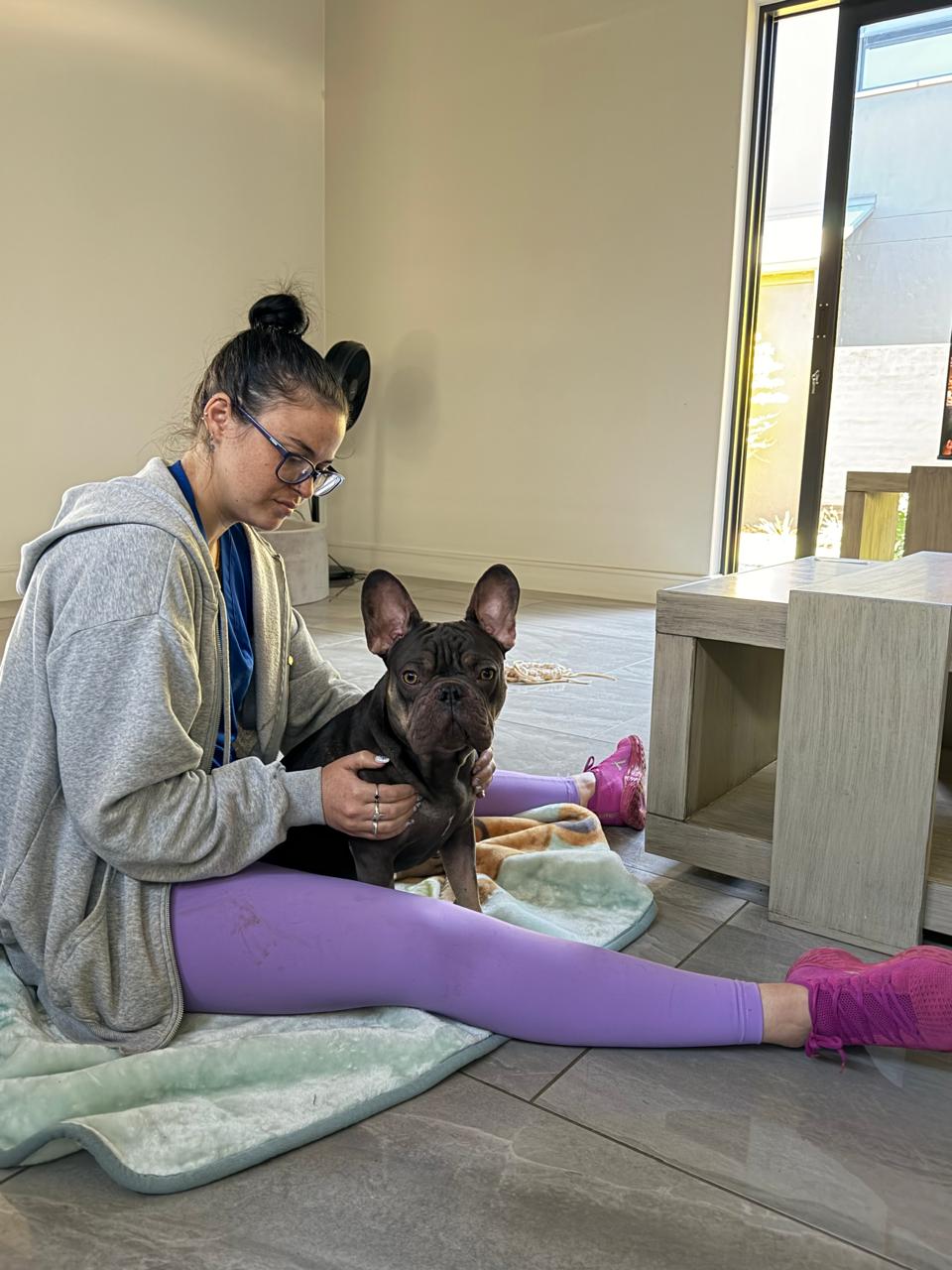 Savannah Kloeck assessing a French bulldog at home